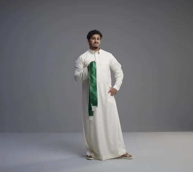 Saudi Man Holding Green National Scarf in Studio