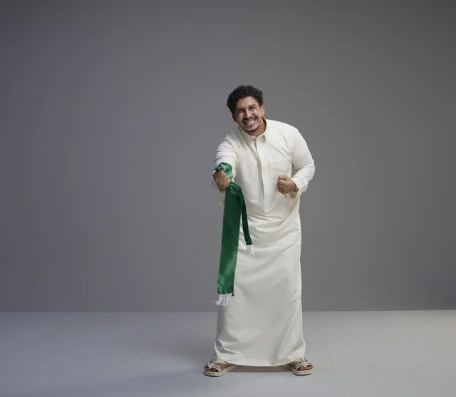 Saudi Man with National Scarf Celebrating in Studio