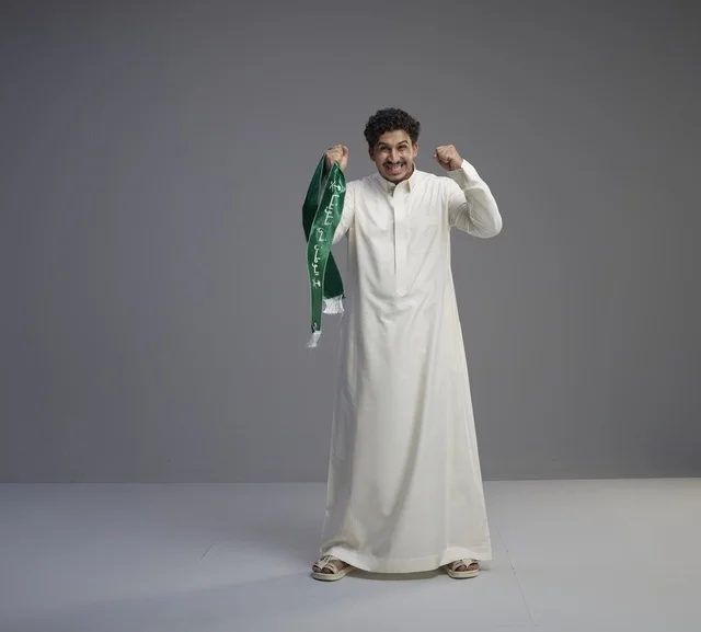 Saudi Man with National Scarf Celebrating in Studio