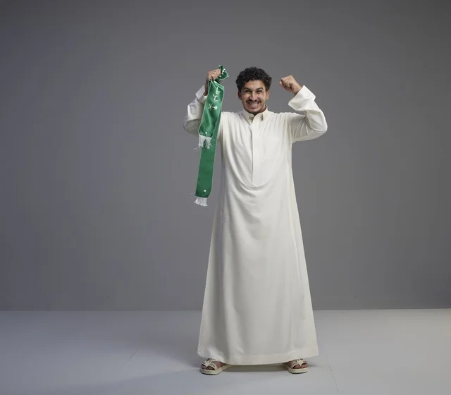 Saudi Man with National Green Scarf Cheering in Studio