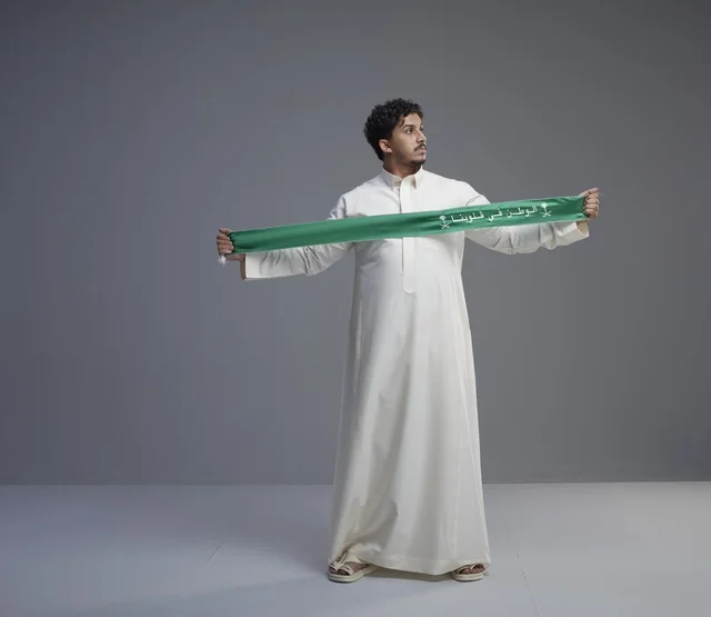 Saudi Man with National Scarf in Studio Setting
