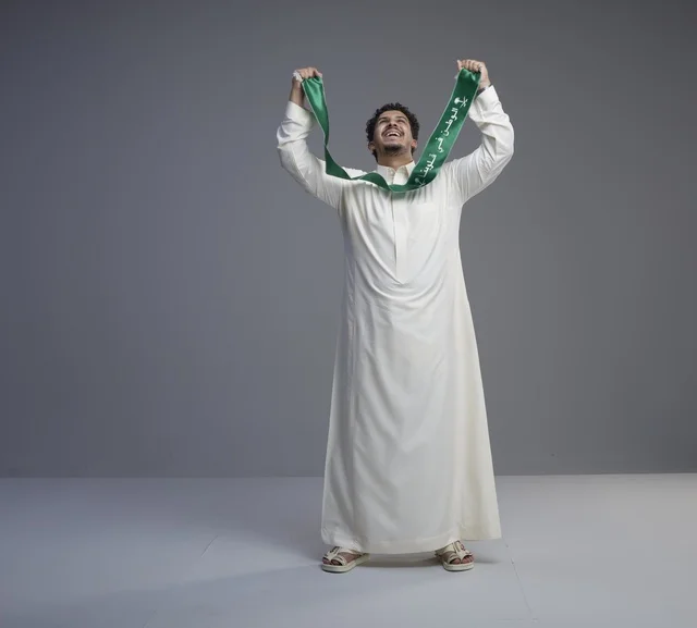 Saudi Man Holding National Scarf in Studio
