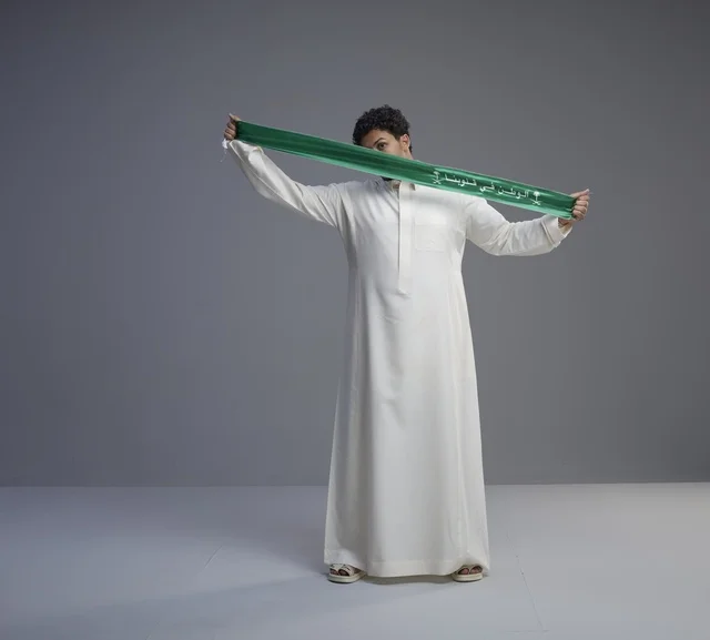 Saudi Man Holding Patriotic Green Scarf