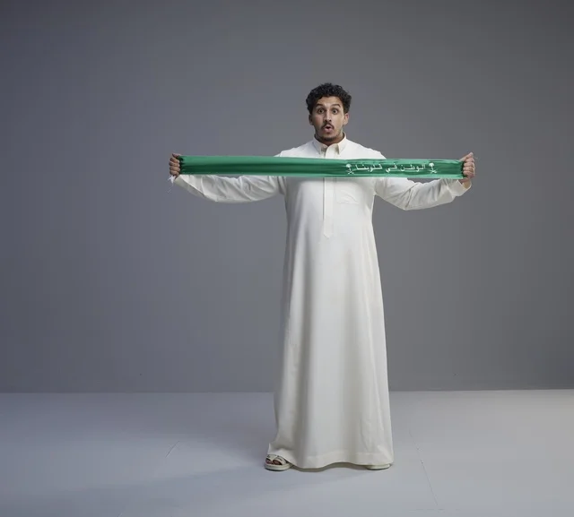 Saudi Man Holding Green National Scarf Studio Portrait