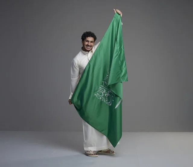 Saudi Man Holding Saudi Arabia Flag in Studio