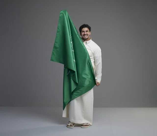 Saudi Man Holding Saudi National Flag in Studio