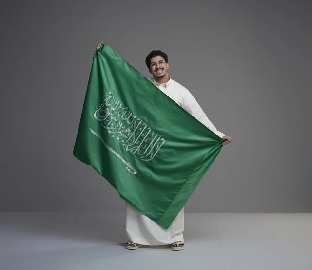 Saudi Man Holding Saudi Arabia Flag in Studio