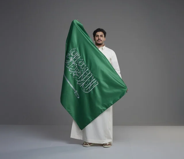 Saudi Man Holding National Flag in Studio
