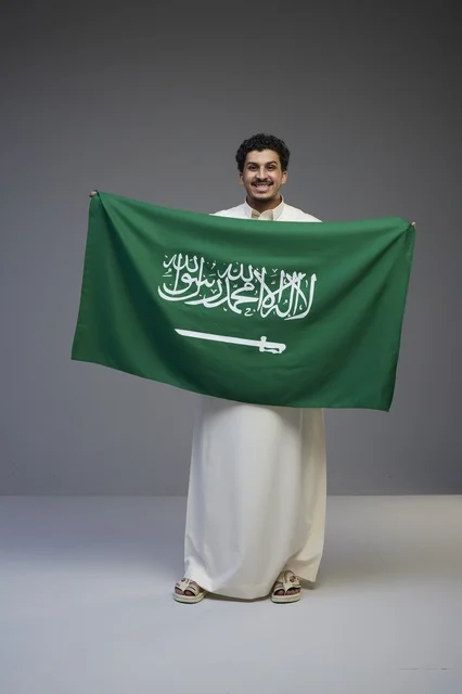 Saudi Man Holding National Flag in Studio