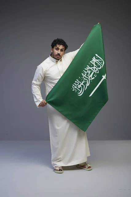 Saudi Man Holding National Flag in Studio