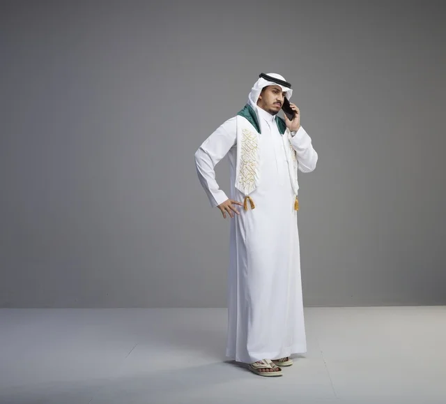 Saudi Graduate Talking on Smartphone in Studio