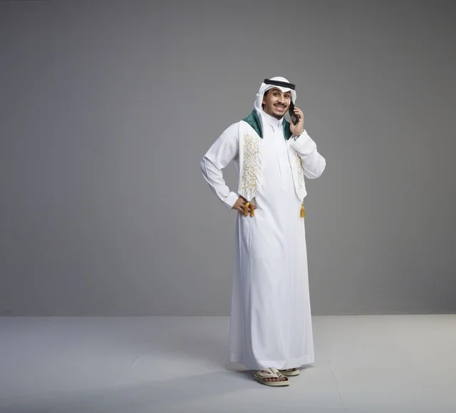 Saudi Graduate Talking on Smartphone in Studio Setting