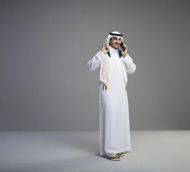 Saudi Graduate Talking on Smartphone in Studio Shot