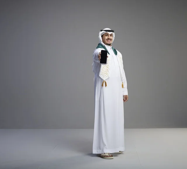 Saudi Graduate Holding Smartphone Blank Screen Studio