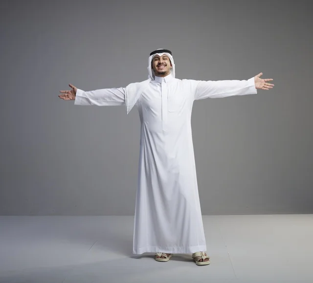 Saudi Man in White Thob with Open Arms in Studio