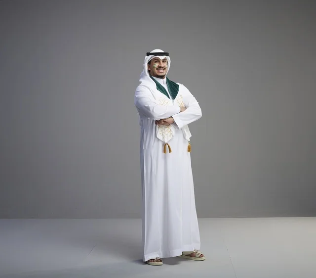 Saudi Male Graduate in Traditional Thobe and Green Sash