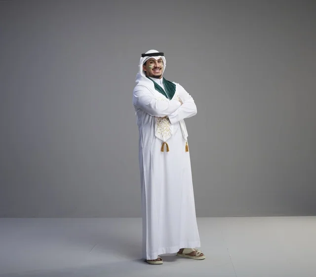 Saudi Graduate in Traditional Dress on Grey Background Saudi Graduate in Traditional Dress on Grey Background