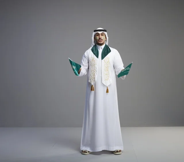 Saudi Man Holding National Flags in Studio