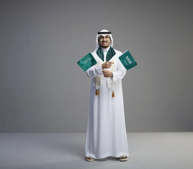 Saudi Man Holding National Flags in Studio