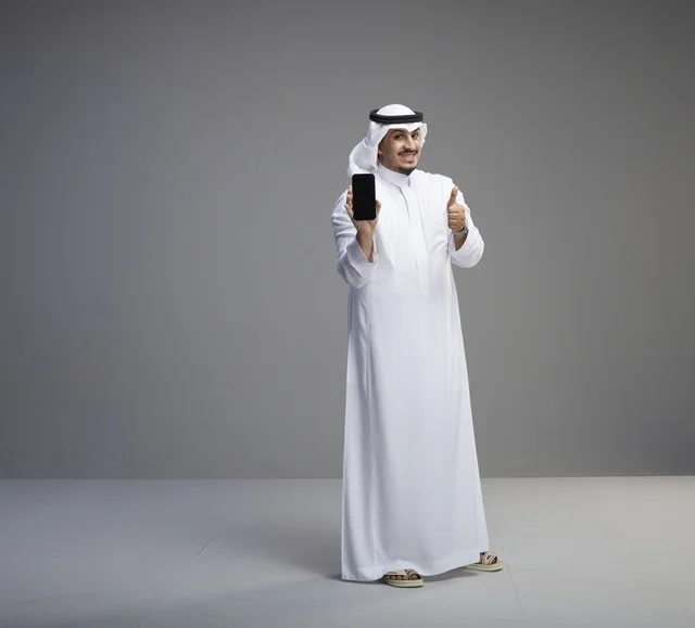 Saudi Man Holding Smartphone with Blank Screen