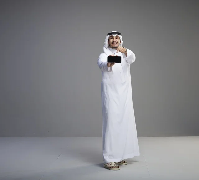 Saudi Man Pointing to Blank Smartphone Screen