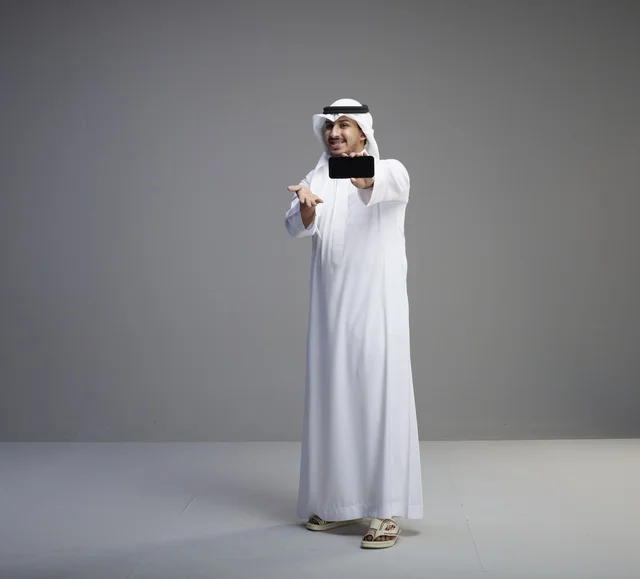 Saudi Man Holding Blank Smartphone Screen in Studio
