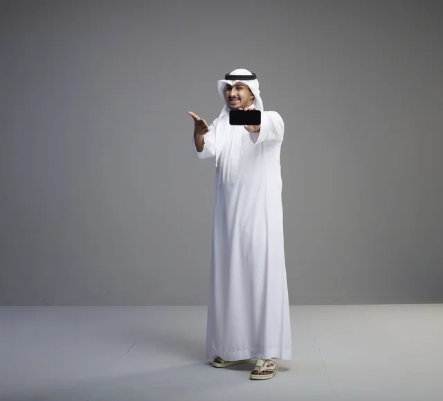 Saudi Man Holding Blank Smartphone Screen in Studio