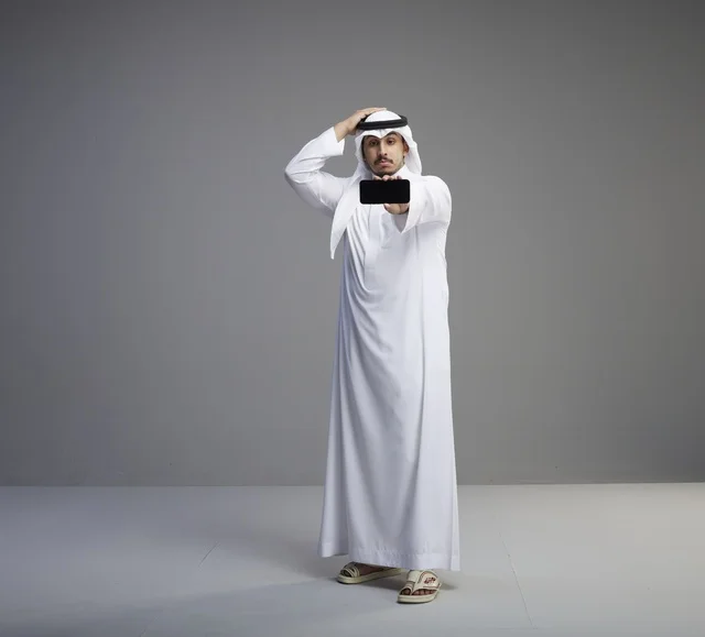 Saudi Man Holding Blank Smartphone Screen in Studio