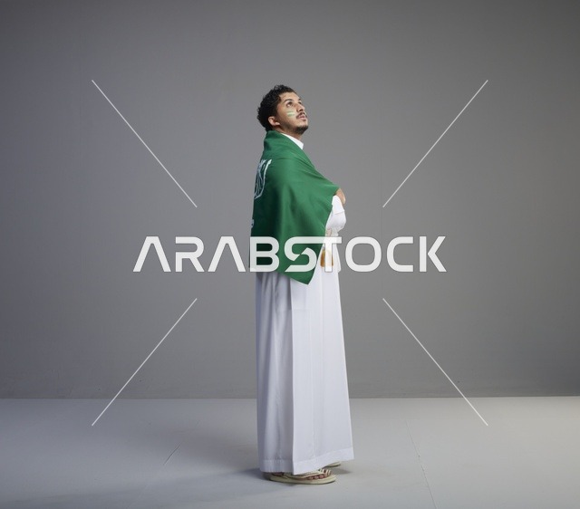 Saudi Man in Thobe Draped with Saudi Arabia Flag
