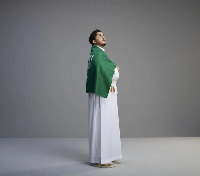 Saudi Man in Thobe Draped with Saudi Arabia Flag