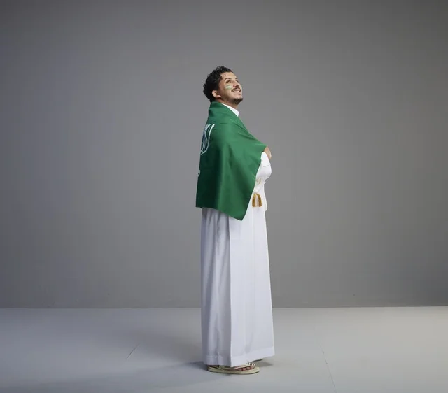 Saudi Man Wrapped in Saudi National Flag Studio Portrait