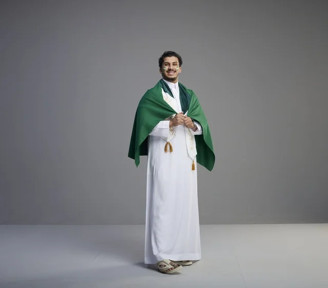 Saudi Man in Thobe Wrapped in National Flag