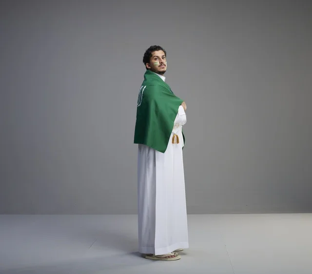 Saudi Man with National Flag on Grey Background