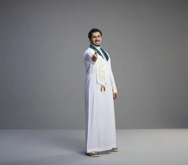 Saudi Man in National Day Attire with Thumbs Up