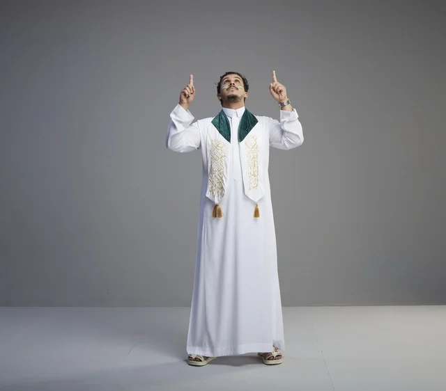 Saudi Man in National Dress Pointing Upward