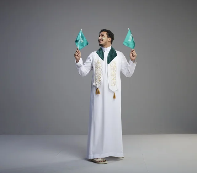Saudi Man Holding National Flags for National Day