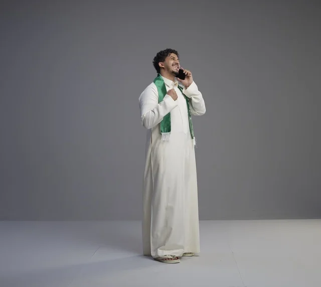 Saudi Man in Thobe Talking on Smartphone in Studio