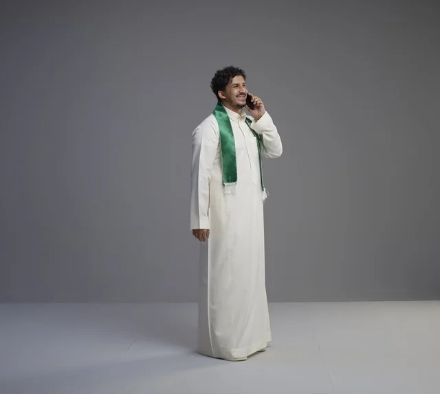 Saudi Man Talking on Smartphone in Traditional Thobe