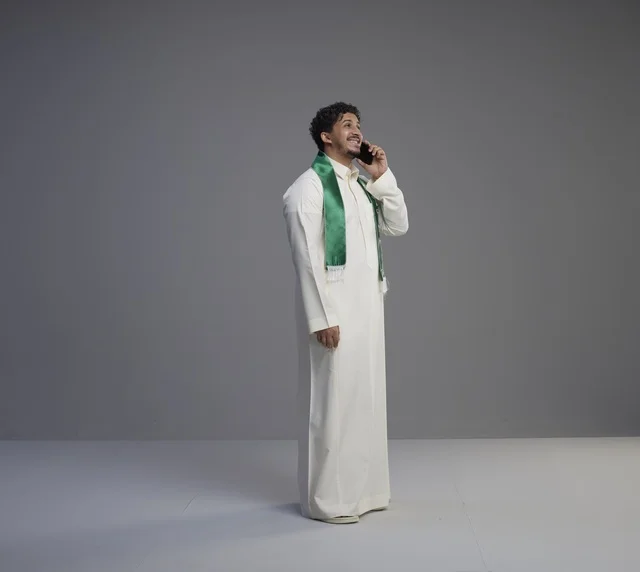 Saudi Man in Thobe Talking on Smartphone in Studio