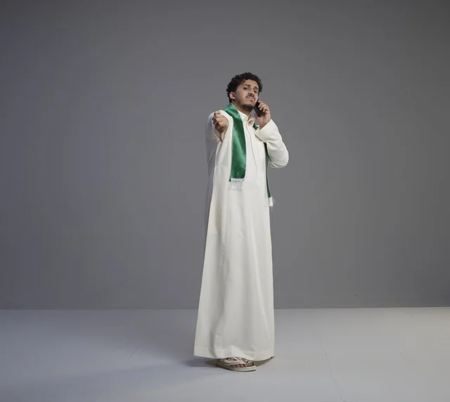 Saudi Man Talking on Smartphone with Thumbs Down
