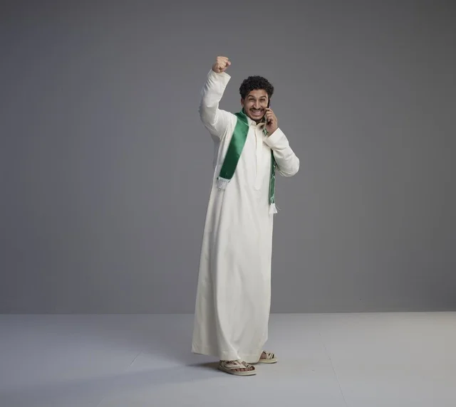 Saudi Man with Smartphone Celebrating National Day