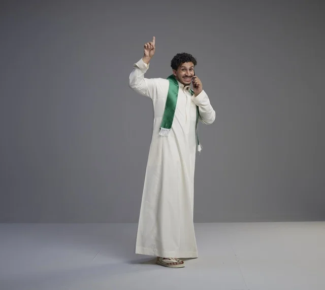 Saudi Man Talking on Smartphone in Traditional Thobe