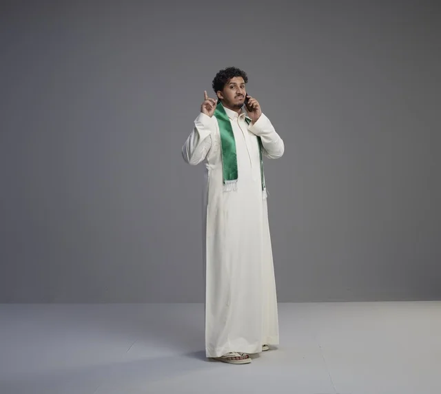 Saudi Man Talking on Smartphone in White Thobe