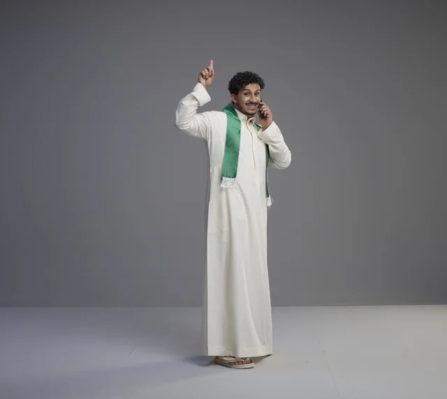 Saudi Man Talking on Smartphone in White Thobe