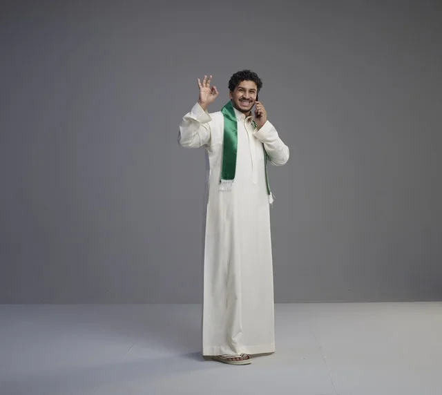Saudi Man Talking on Smartphone with Okay Gesture