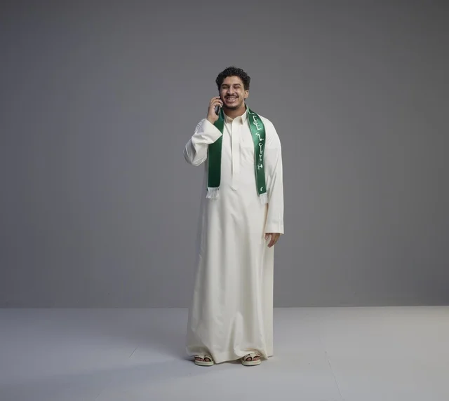 Saudi Man Talking on Smartphone in Traditional Thobe