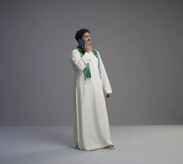 Saudi Man in Thobe Talking on Smartphone in Studio