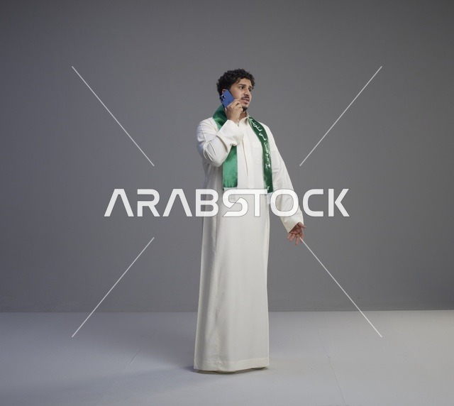 شاب سعودي بالثوب يتحدث عبر الهاتف في الاستوديو