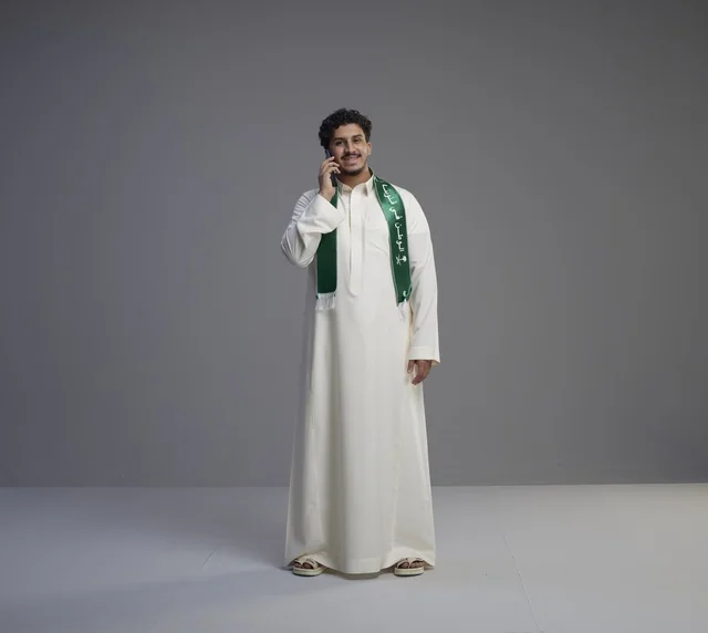Saudi Man in Thobe Talking on Smartphone in Studio