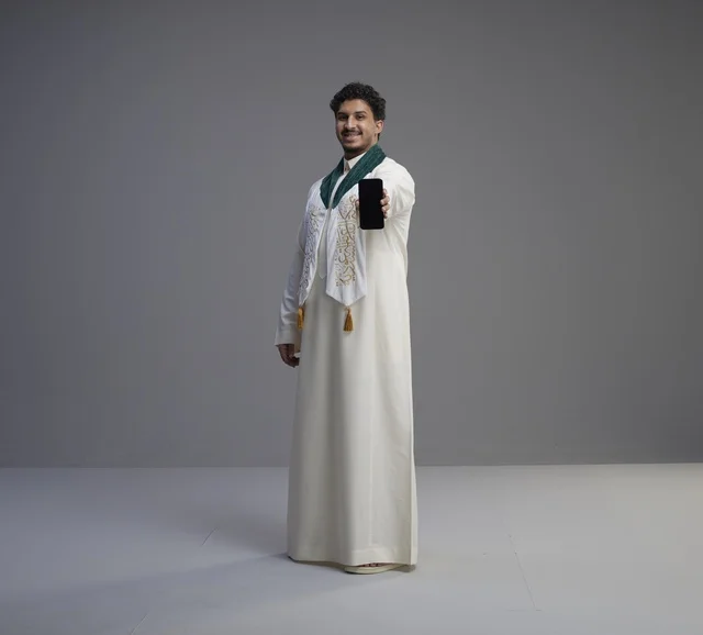 Saudi Man Holding Blank Smartphone Screen in Studio Setup